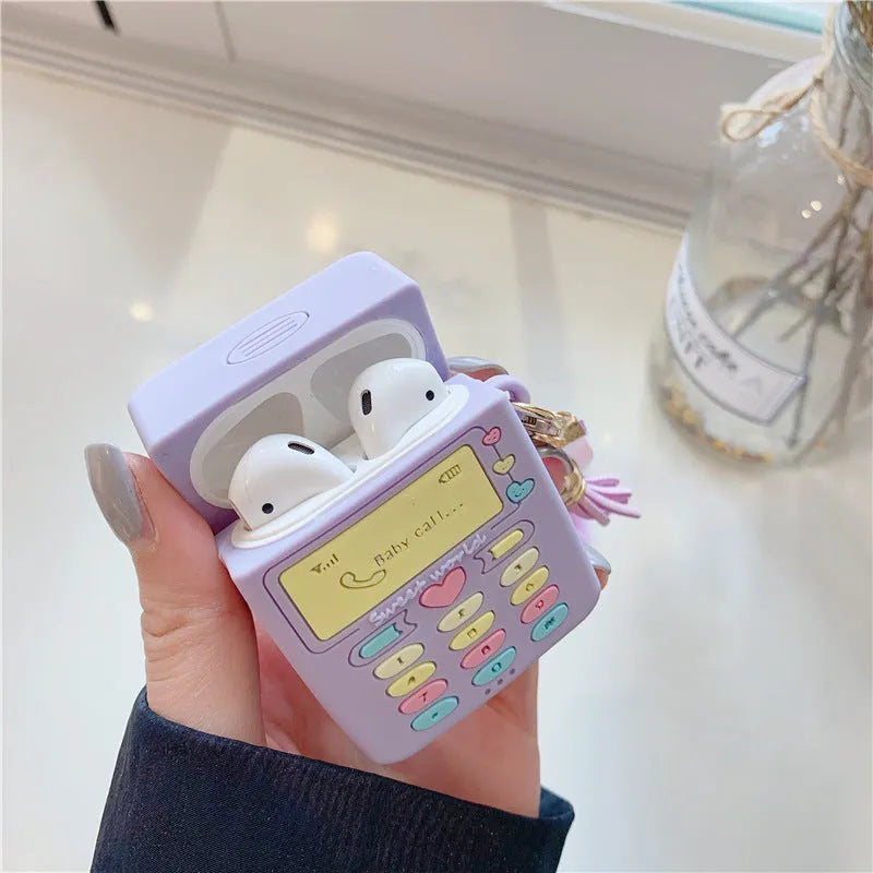 Purple silicone AirPods protective case with clamshell design and attached fur ball pendant