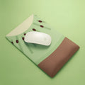 Cute green Kiwi character design on a grey mouse pad with thick wrist support.