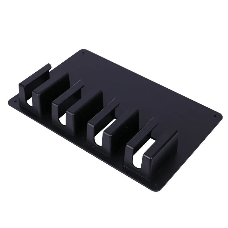 Black plastic wall-mounted rack holding four hair clippers with included screws for installation.