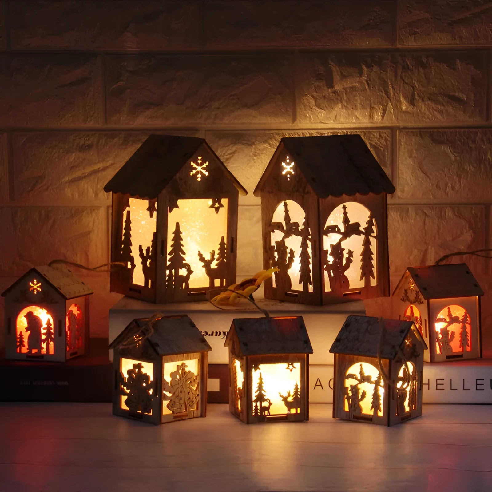 Three wooden Christmas house decorations including log bell, old man house, and snowman house in natural wood colour