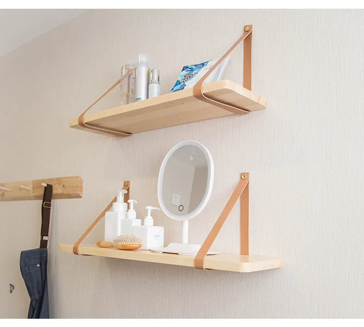 Pine wood wall-mounted shelf in Nordic style for storing remotes, books, and cosmetics.