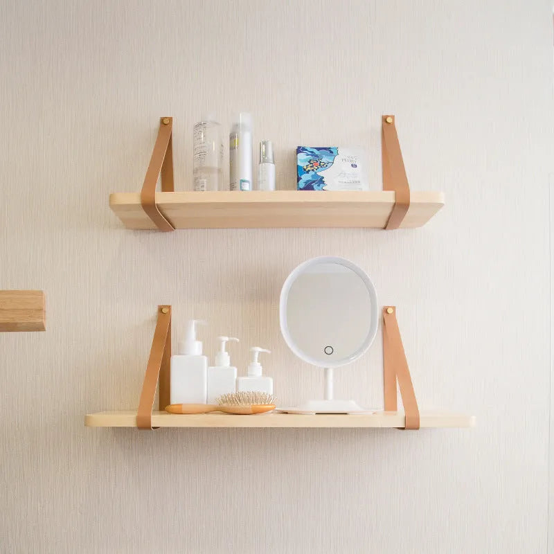 Pine wood wall-mounted shelf in Nordic style for storing remotes, books, and cosmetics.