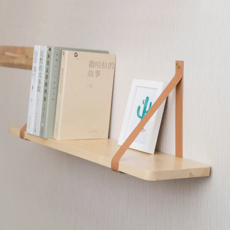 Pine wood wall-mounted shelf in Nordic style for storing remotes, books, and cosmetics.