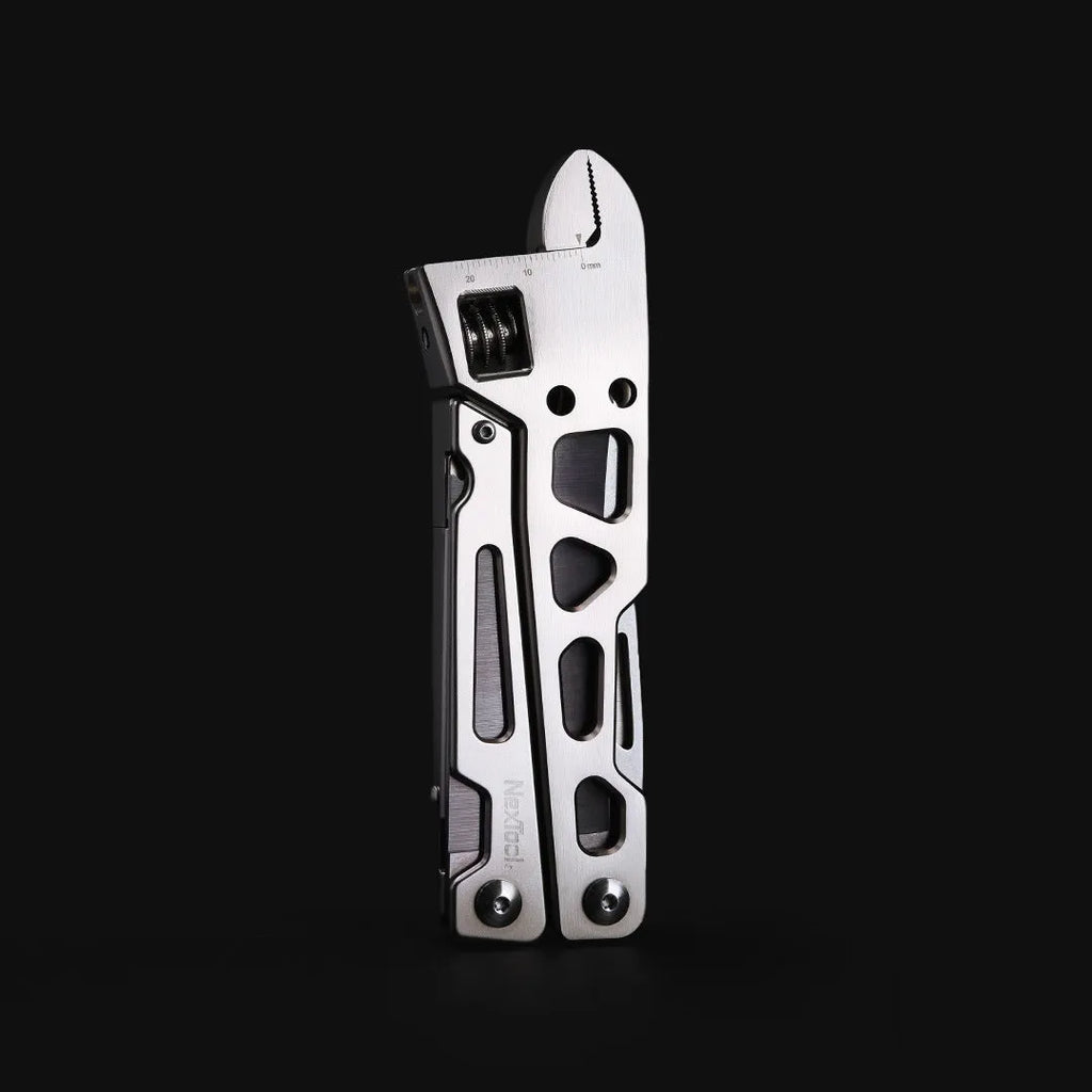 Stainless steel multi-function tool with wrench, knife blade, and needle nose pliers heads.