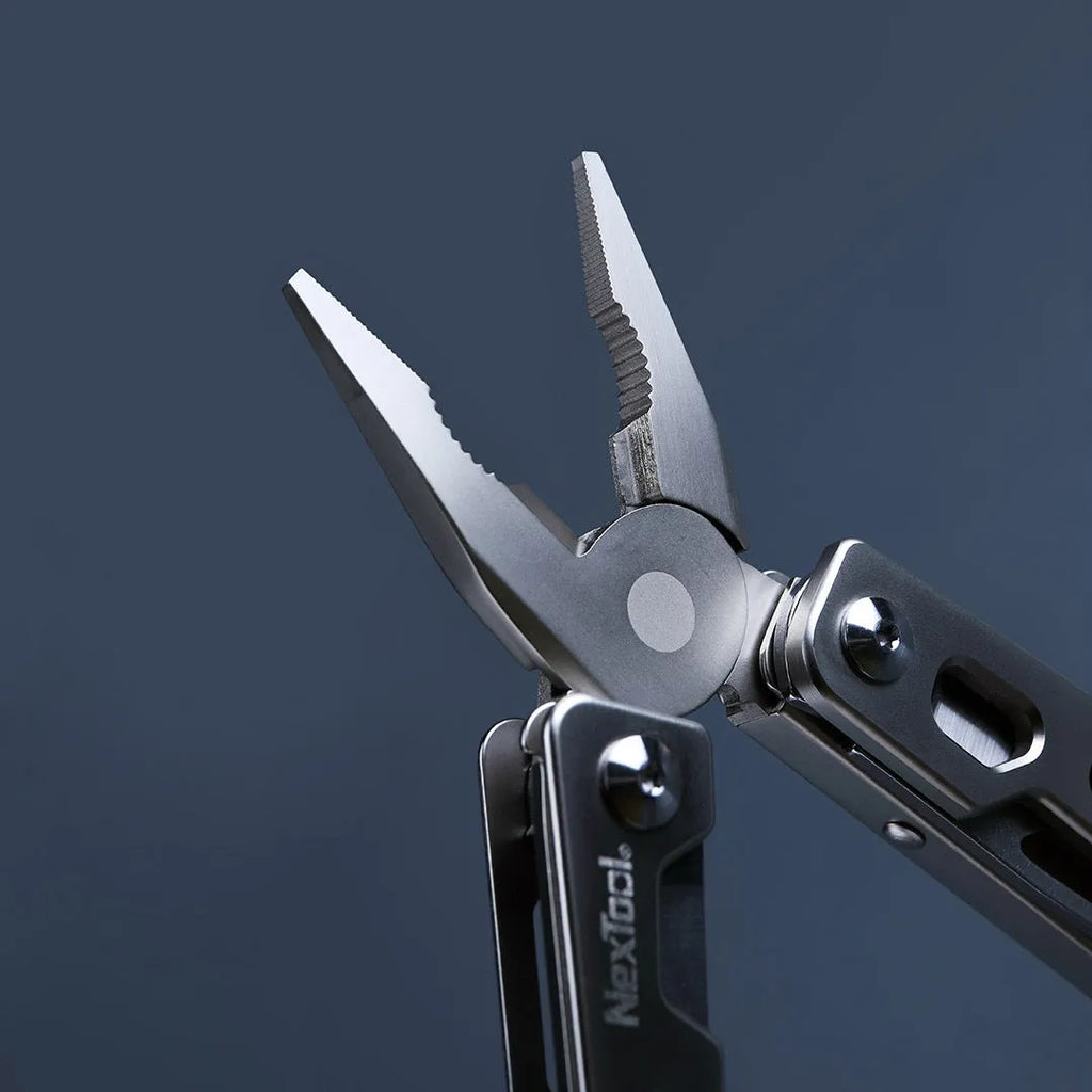 Stainless steel multi-function tool with wrench, knife blade, and needle nose pliers heads.