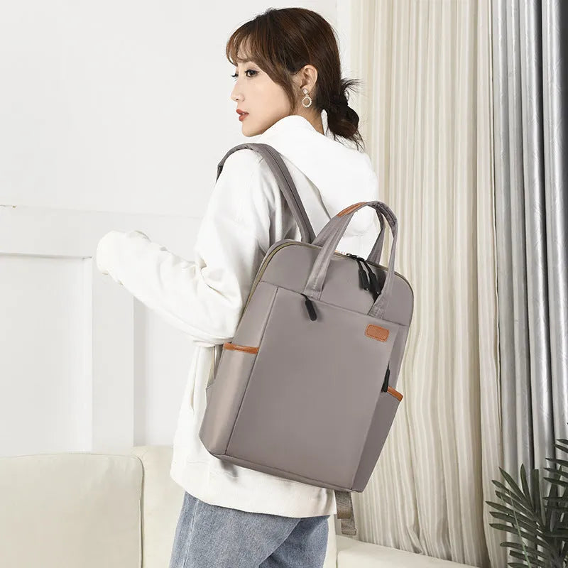 15.6-inch canvas computer backpack in black with waterproof finish and multiple internal compartments