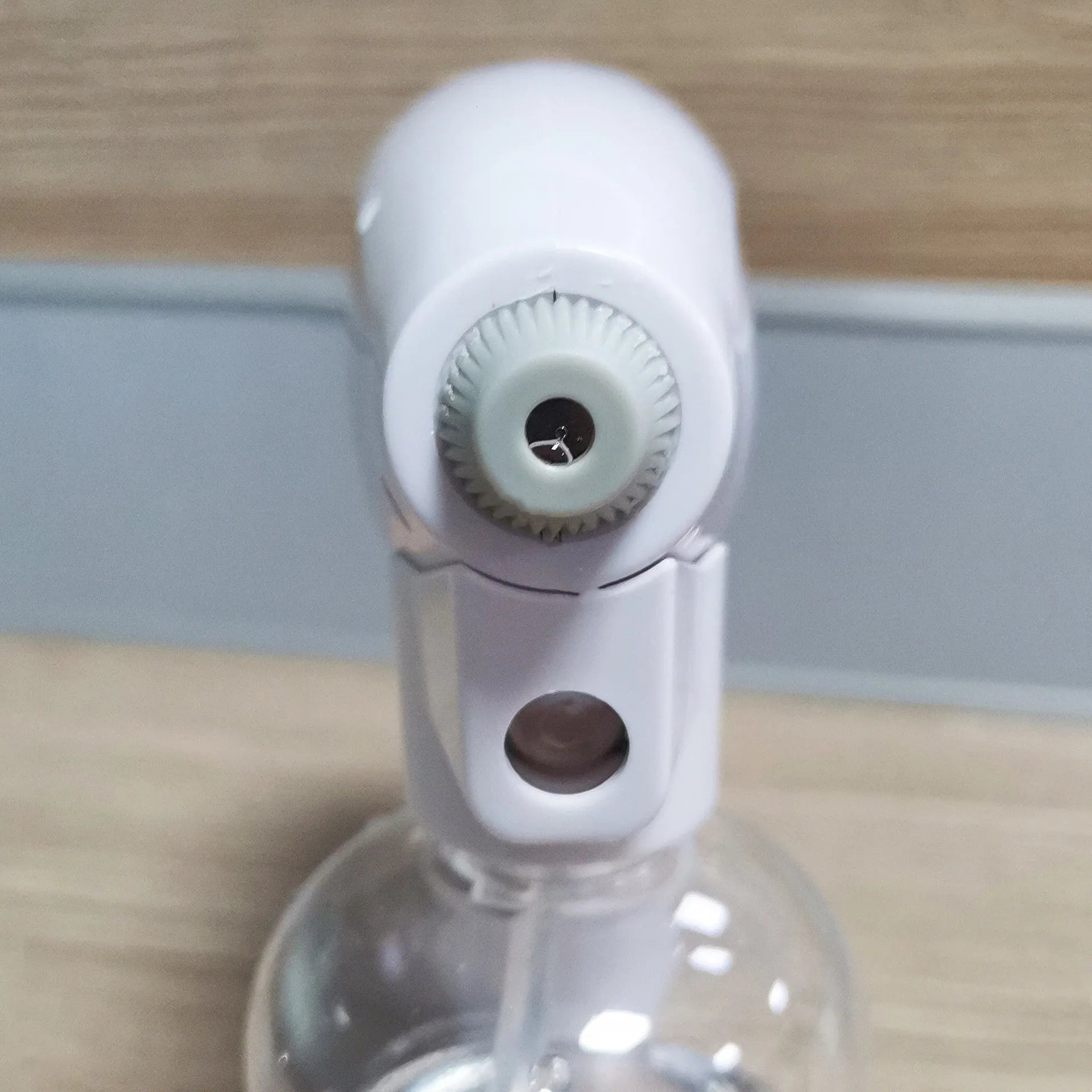 White handheld cordless electric spray disinfection gun with USB charging cable.