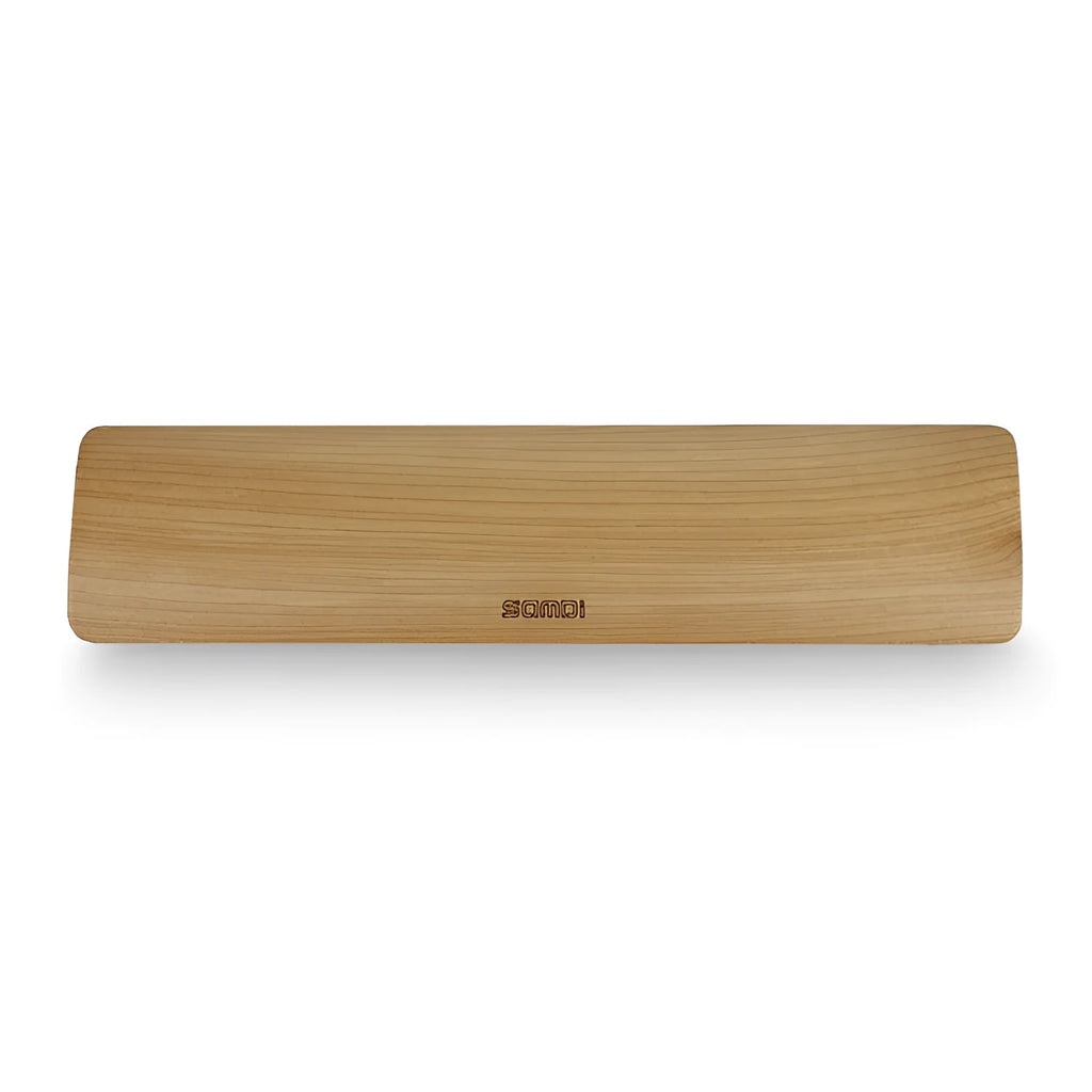 Single-sided wooden keyboard wrist pad in birch wood with machined finish on a desk
