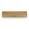 Single-sided wooden keyboard wrist pad in birch wood with machined finish on a desk