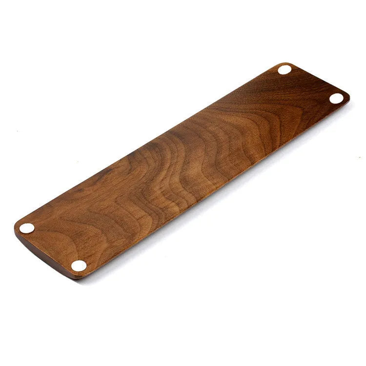 Single-sided wooden keyboard wrist pad in birch wood with machined finish on a desk