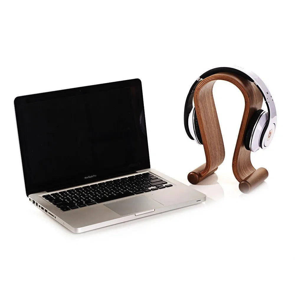Solid wood earphone display rack in coffee finish on a desk with headphones