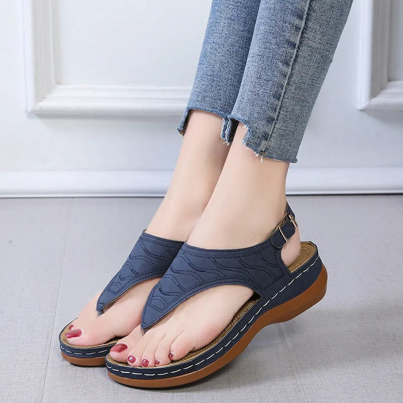Women's wedge heel sandals with an adjustable buckle strap in a solid colour