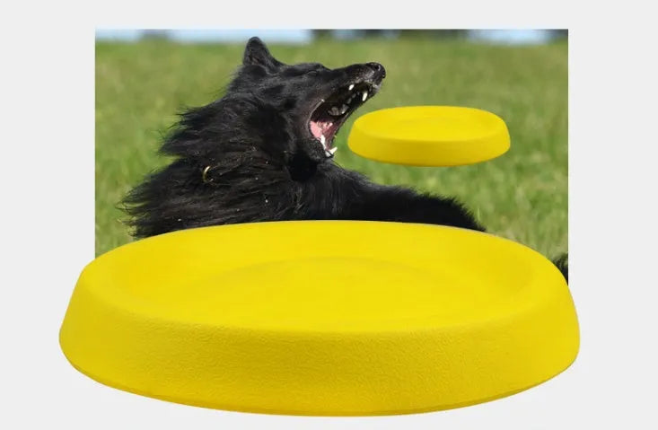 Yellow EVA plastic throwing disc dog training toy on grass