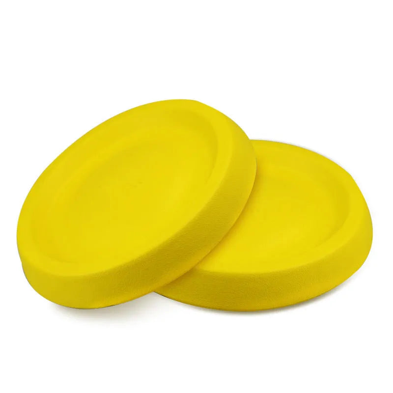 Yellow EVA plastic throwing disc dog training toy on grass