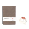 Solid colour thickened page notebook in green, showing A5 size on a wooden desk.