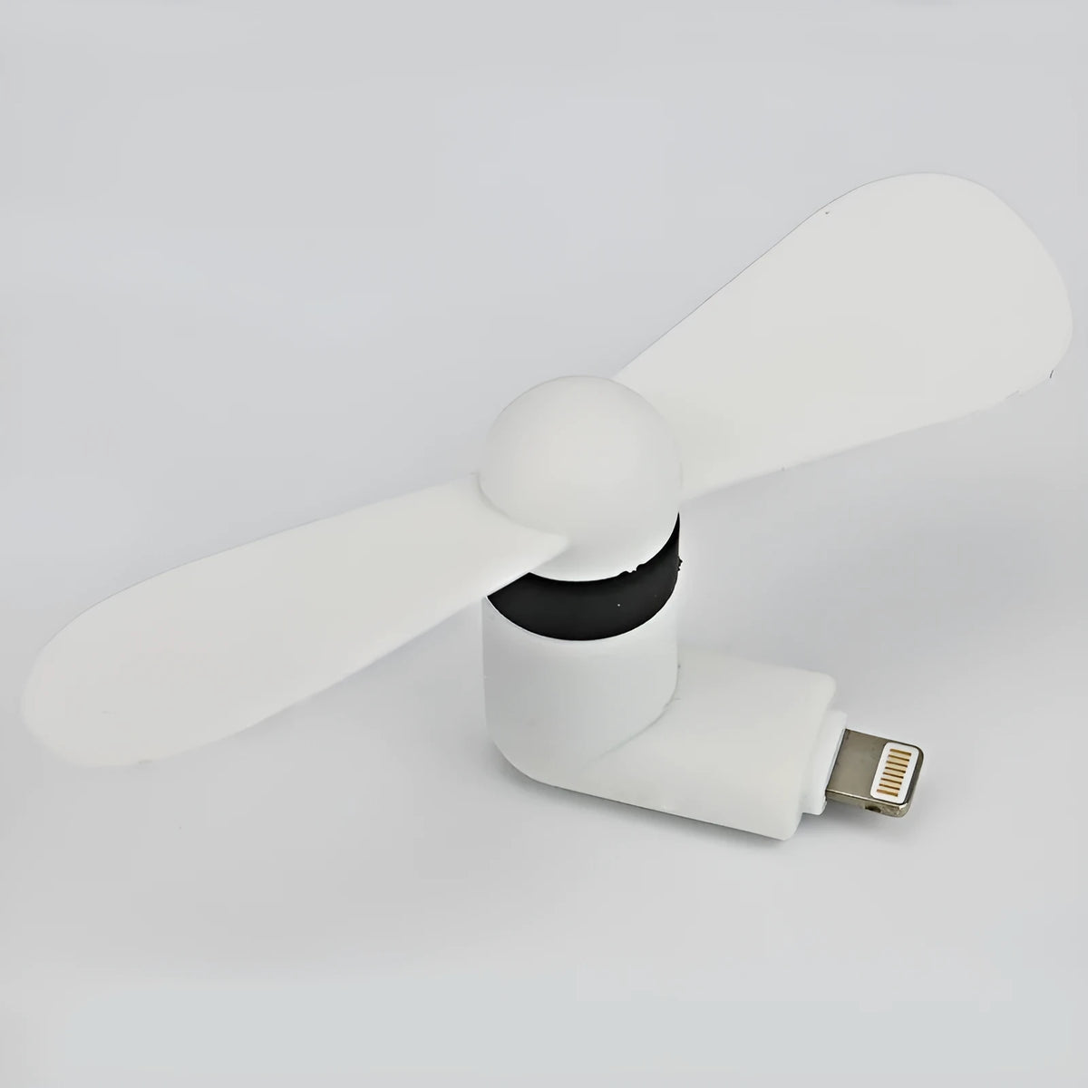 White mobile phone mini fan attached to smartphone showing plastic blades and rotary switch
