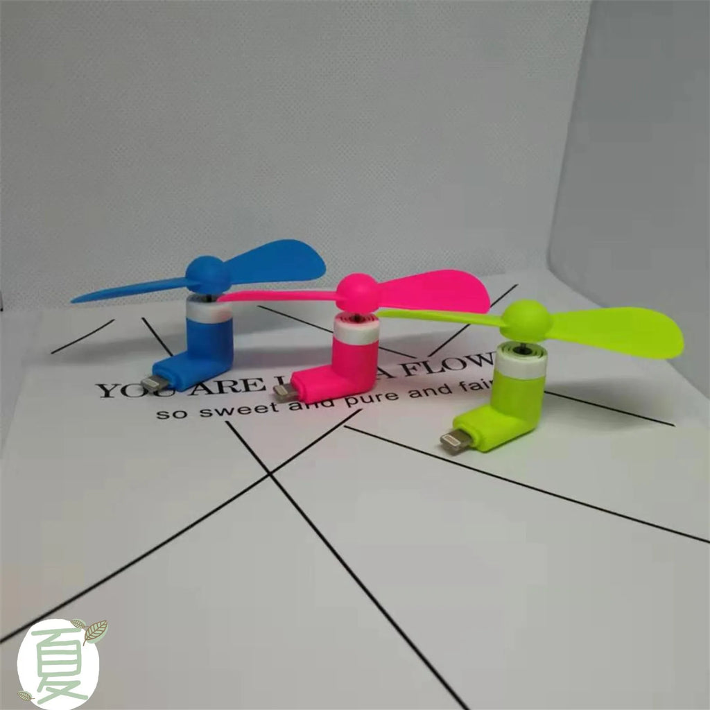 White mobile phone mini fan attached to smartphone showing plastic blades and rotary switch