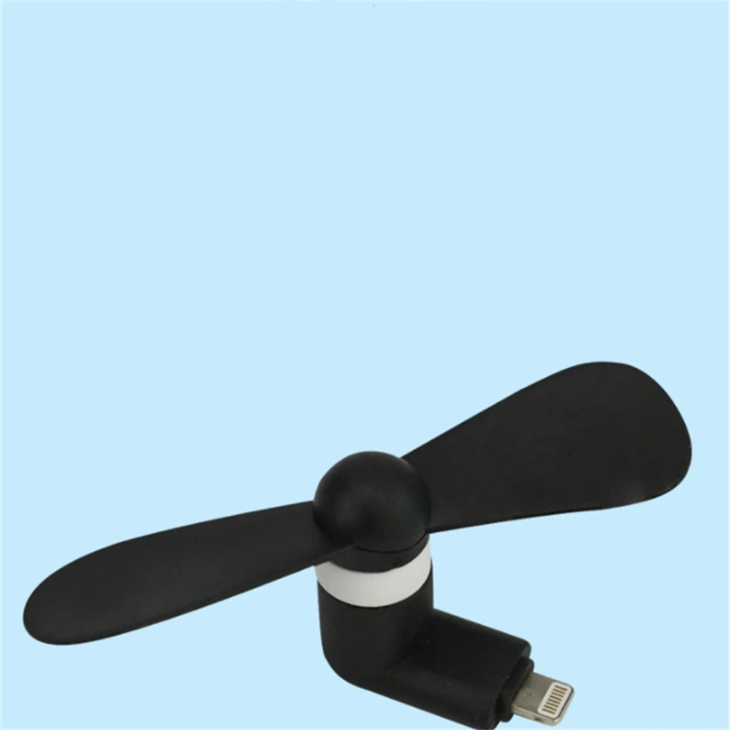 White mobile phone mini fan attached to smartphone showing plastic blades and rotary switch