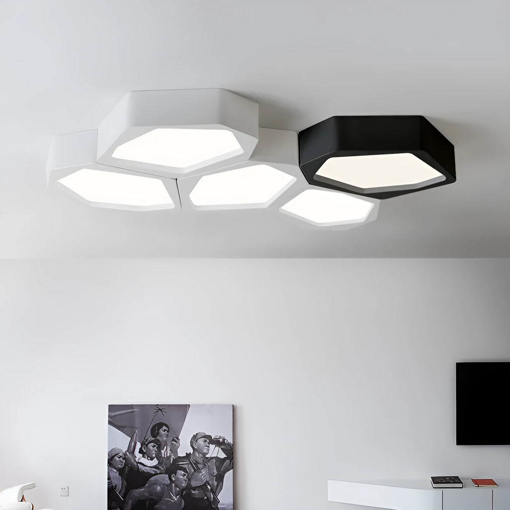 Geometric shaped black iron LED wall light with remote control on a living room wall.