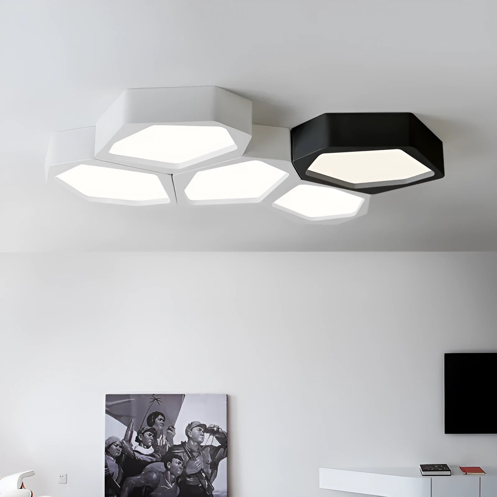 Geometric shaped black iron LED wall light with remote control on a living room wall.