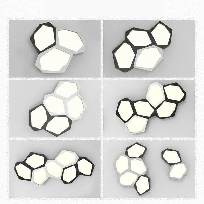 Geometric shaped black iron LED wall light with remote control on a living room wall.