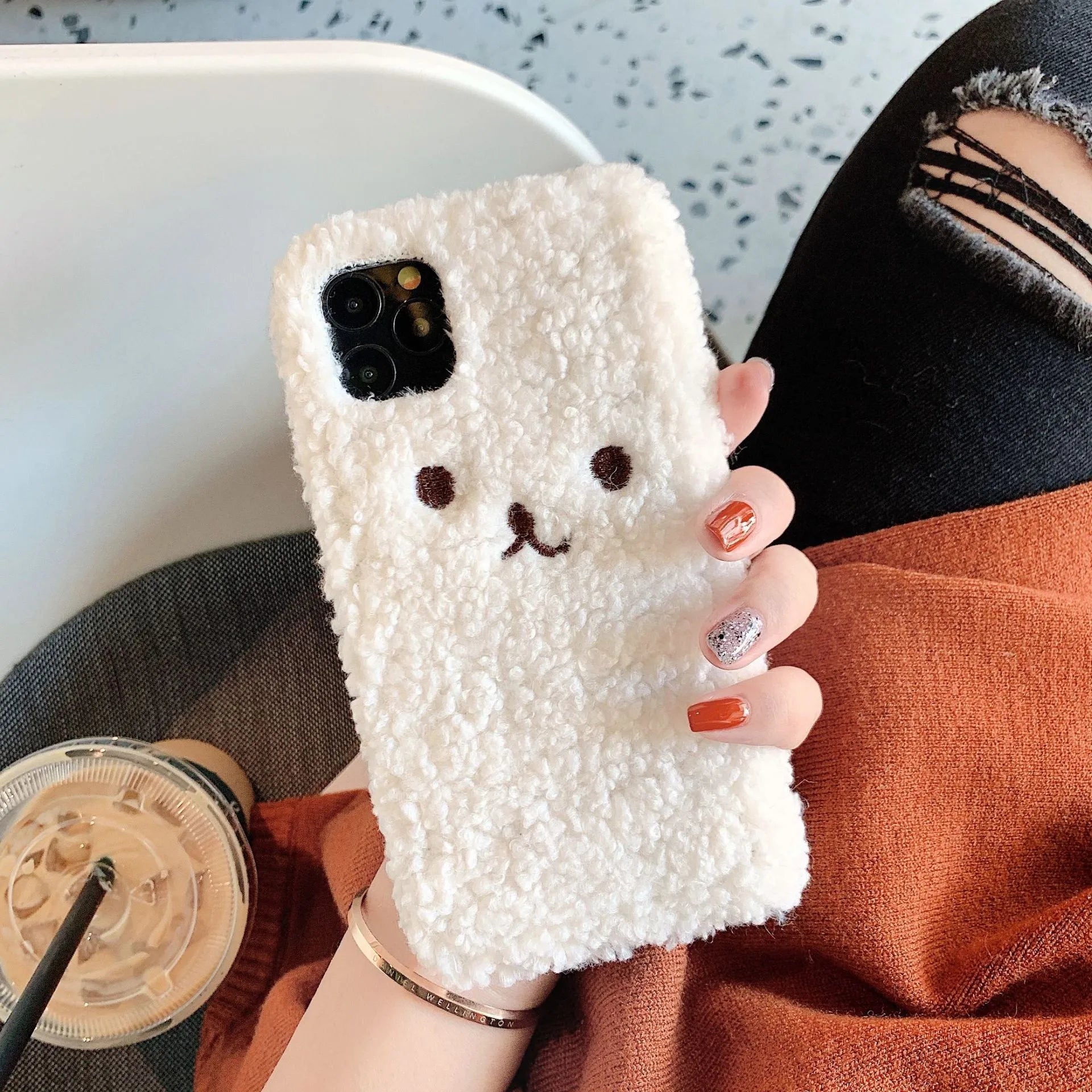 Brown and white embroidery plush cartoon bear face design on a flexible TPU iPhone case.