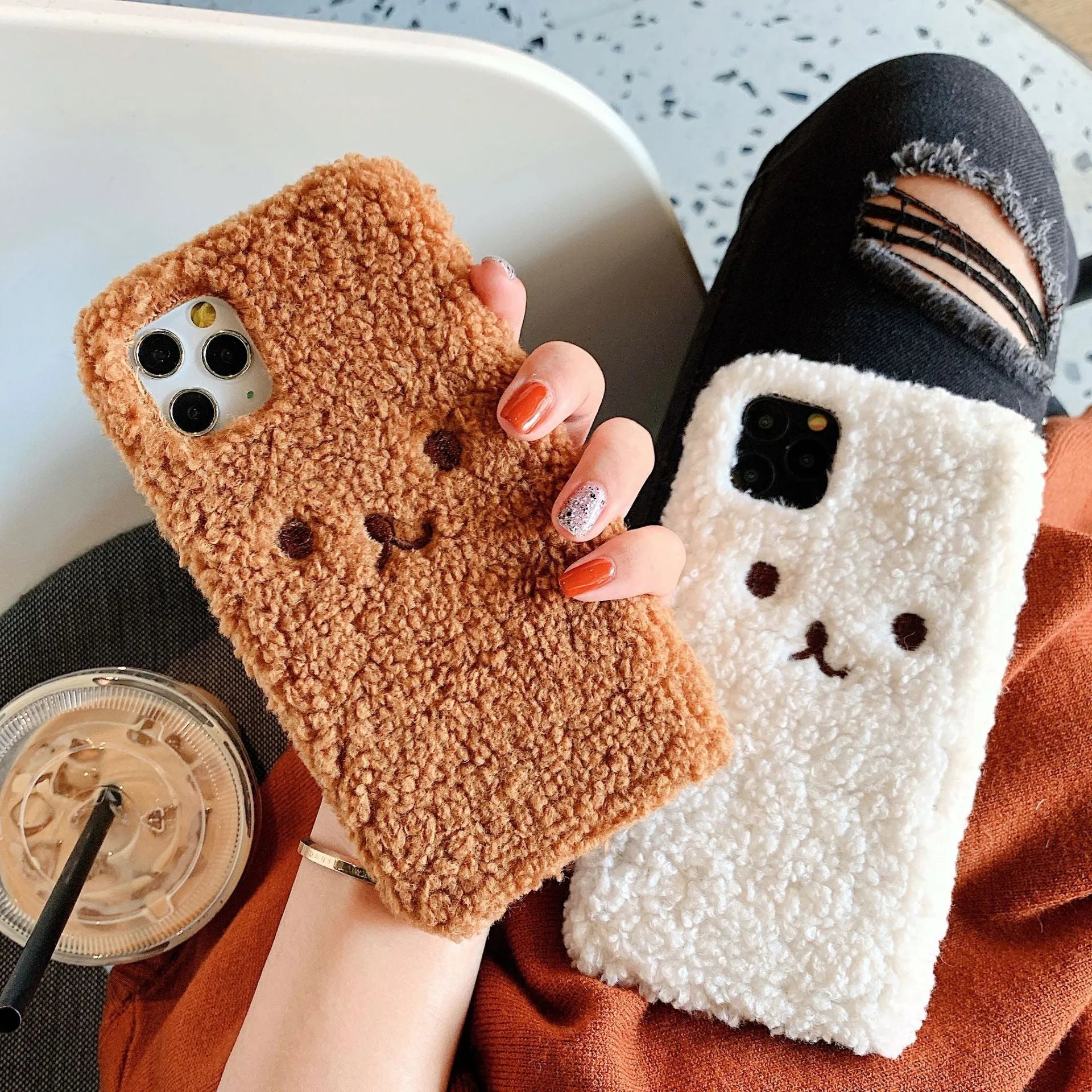 Brown and white embroidery plush cartoon bear face design on a flexible TPU iPhone case.