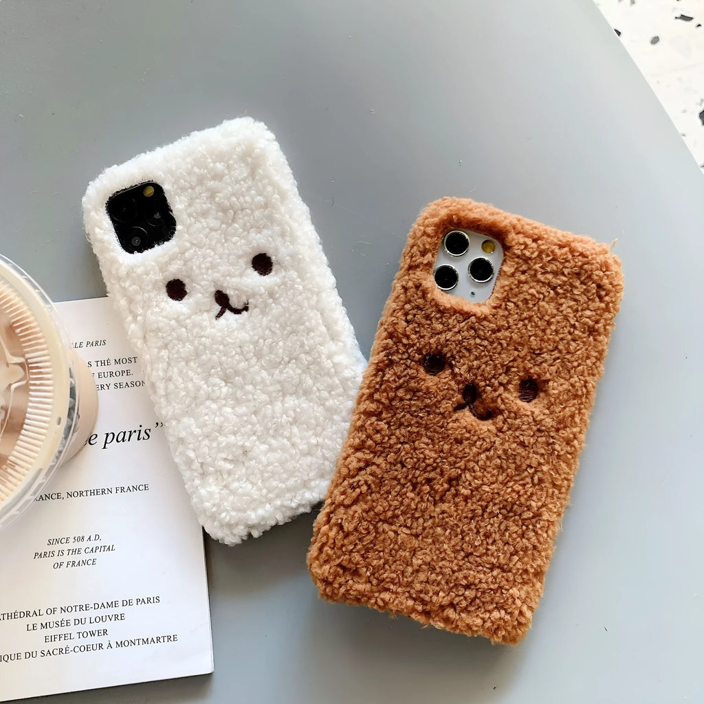 Brown and white embroidery plush cartoon bear face design on a flexible TPU iPhone case.