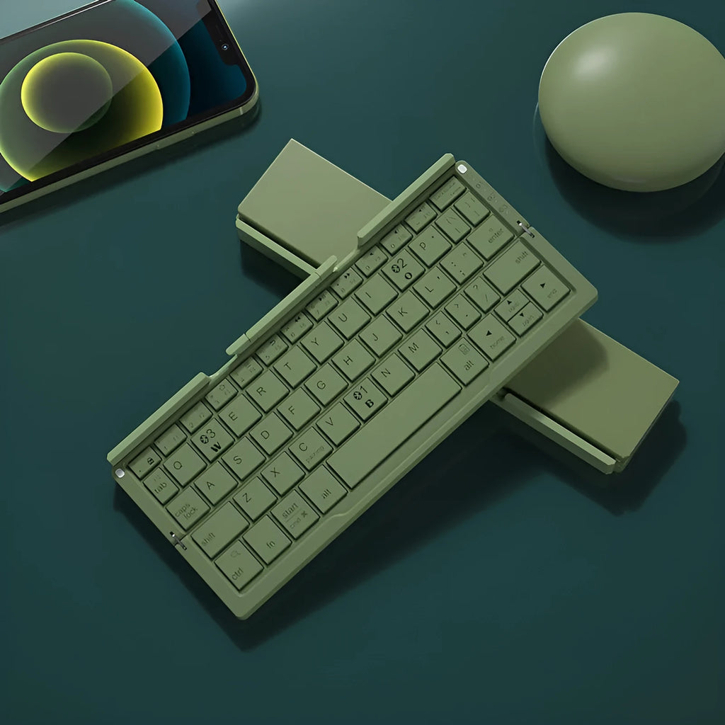 Silver folding Bluetooth keyboard open with phone standing in integrated holder