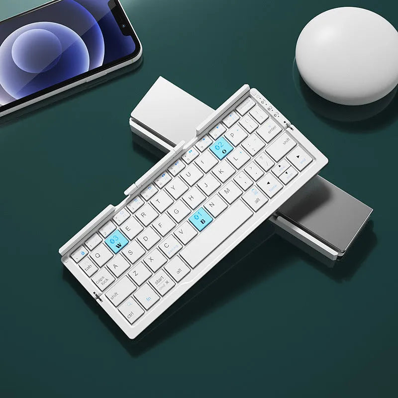 Silver folding Bluetooth keyboard open with phone standing in integrated holder