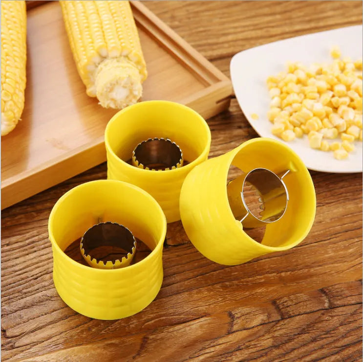 Yellow manual corn grinder thresher with corn-shaped design and PP handle.