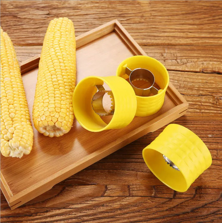Yellow manual corn grinder thresher with corn-shaped design and PP handle.