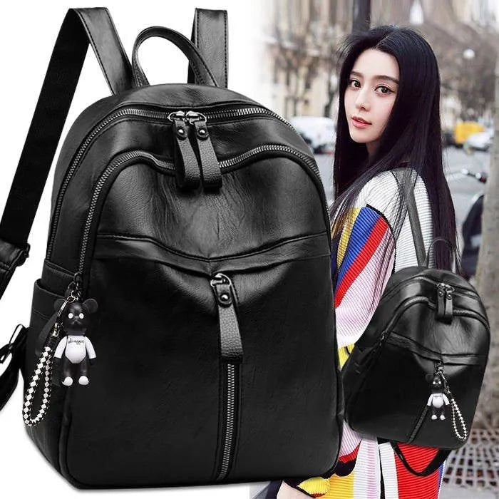 Soft black PU leather backpack with double straps and zipper opening showing medium size and plain design
