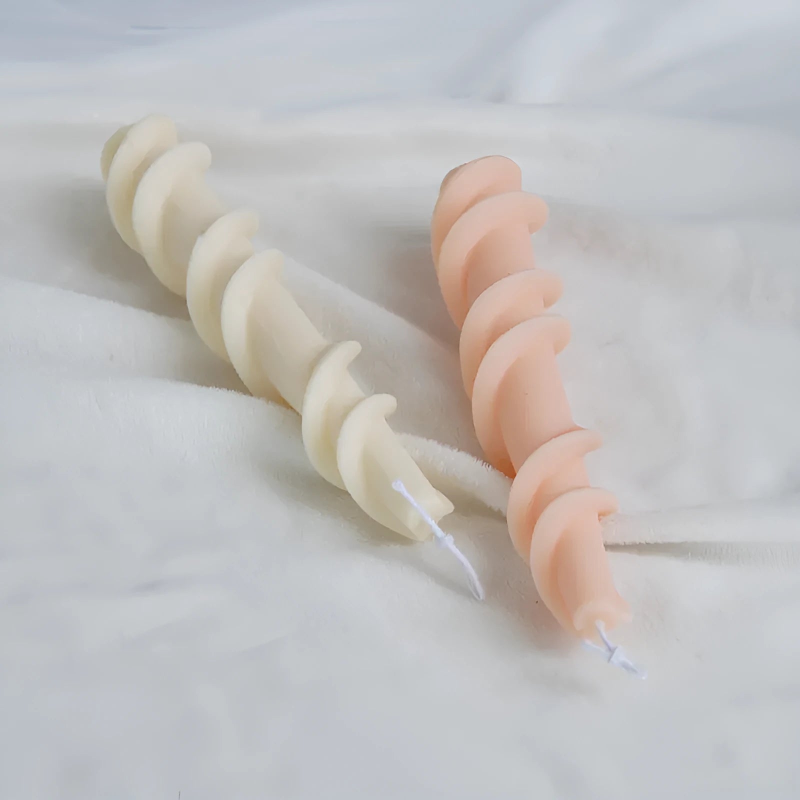 Flexible silicone mould for creating spiral lace rod shaped decorative candles.