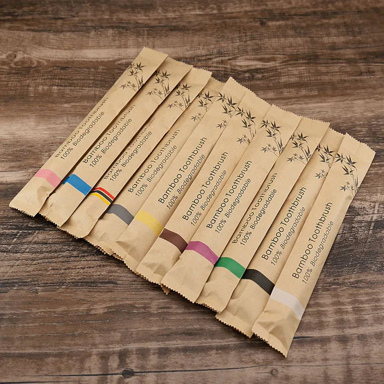 10 bamboo toothbrushes with charcoal bristles in multiple colours including black, green, grey, purple, white and yellow