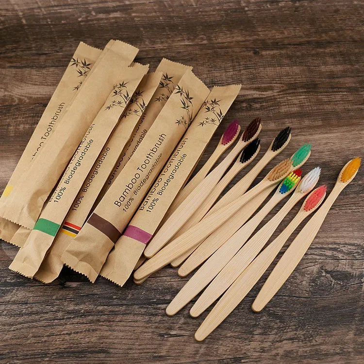 10 bamboo toothbrushes with charcoal bristles in multiple colours including black, green, grey, purple, white and yellow