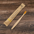 10 bamboo toothbrushes with charcoal bristles in multiple colours including black, green, grey, purple, white and yellow
