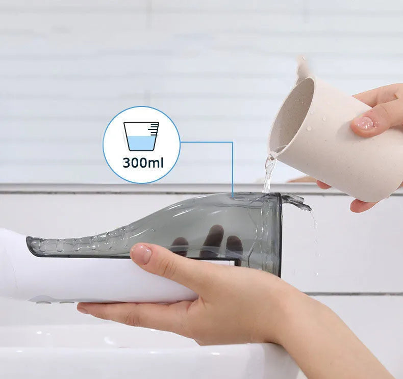 Electric oral irrigator with 330ml water tank, USB charging, and three cleaning modes on a bathroom counter