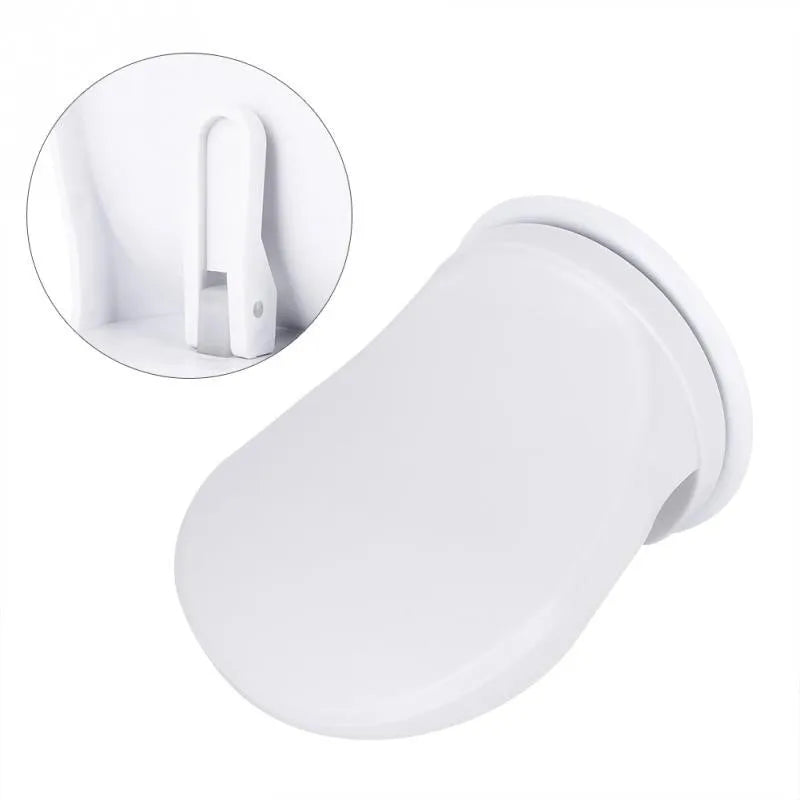 White plastic shower foot rest with suction cups, used as a step for washing feet or shaving legs in the bath or shower.