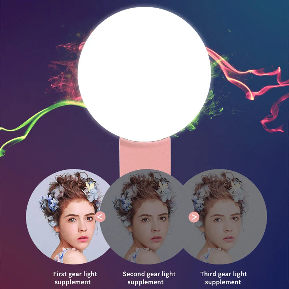 Round white clip-on mini fill light attached to a mobile phone for selfies
