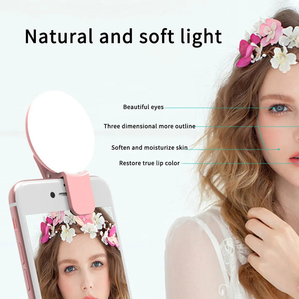Round white clip-on mini fill light attached to a mobile phone for selfies