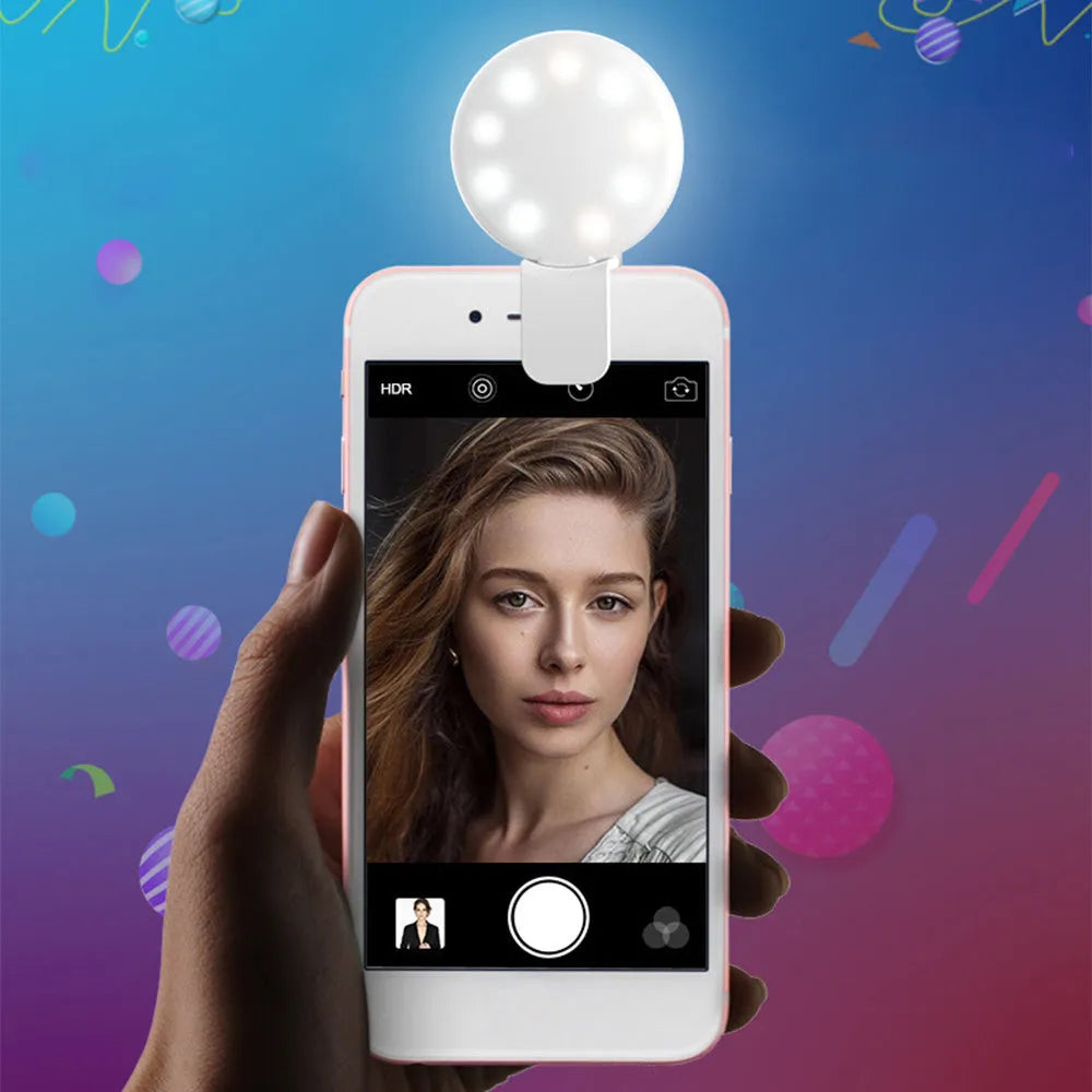 Round white clip-on mini fill light attached to a mobile phone for selfies