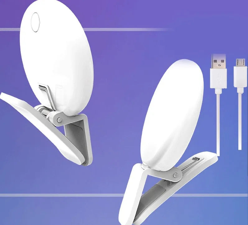 Round white clip-on mini fill light attached to a mobile phone for selfies