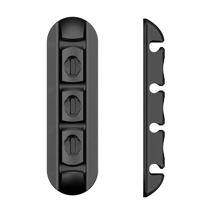 Black soft plastic desktop magnetic charging cable organiser on desk