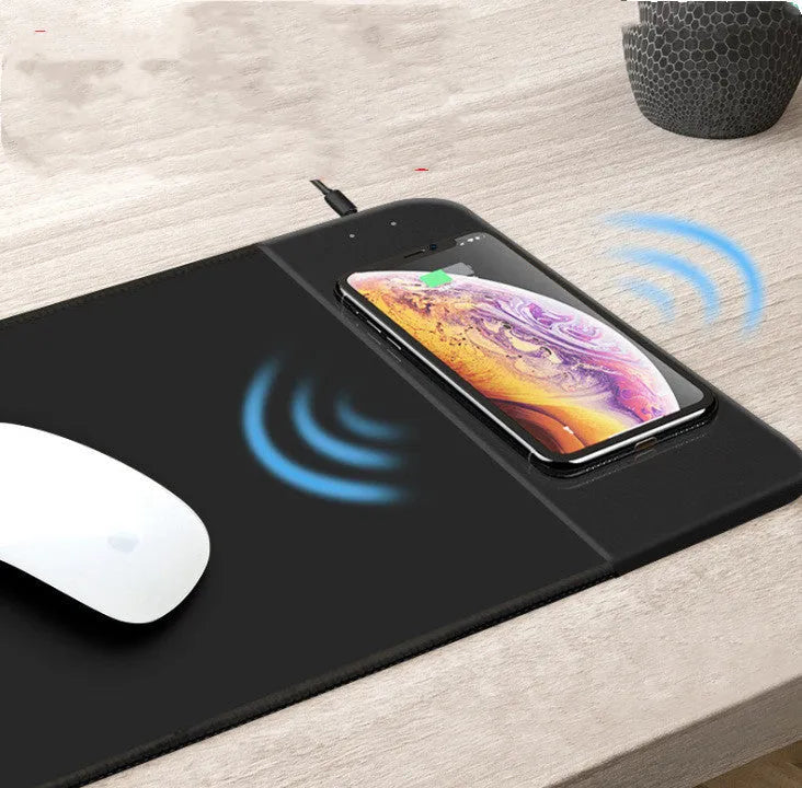 Colourful cartoon wireless charging mouse pad with RGB lighting, showing non-slip rubber base and cloth surface.