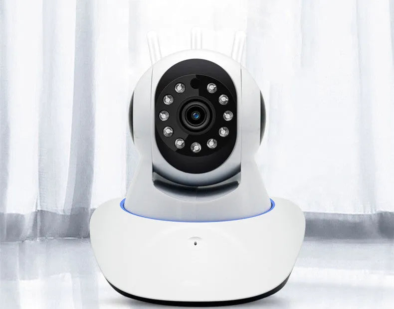 Black wireless camera with three antennas on a desk showing 360-degree rotation for home monitoring
