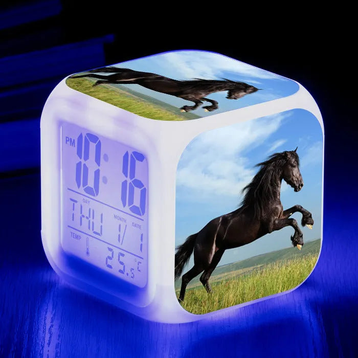 Small square creative alarm clock with colour changing LED digital display on a plexiglass dial.
