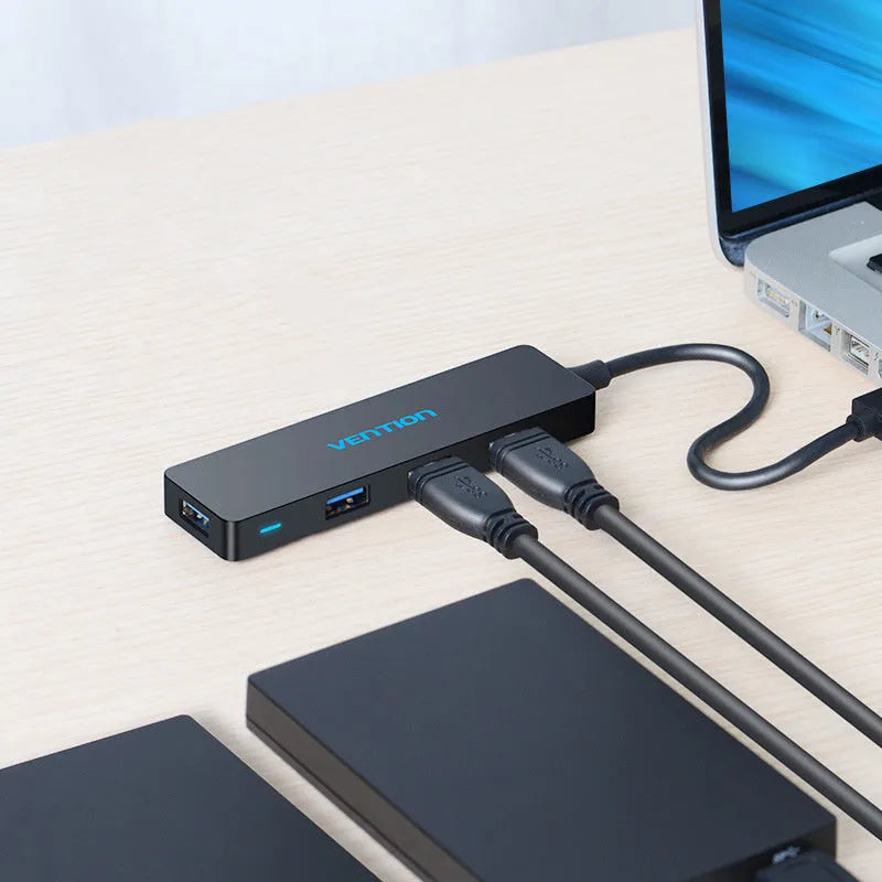 Black four-port USB 3.0 hub with a short cable and nickel-plated connectors