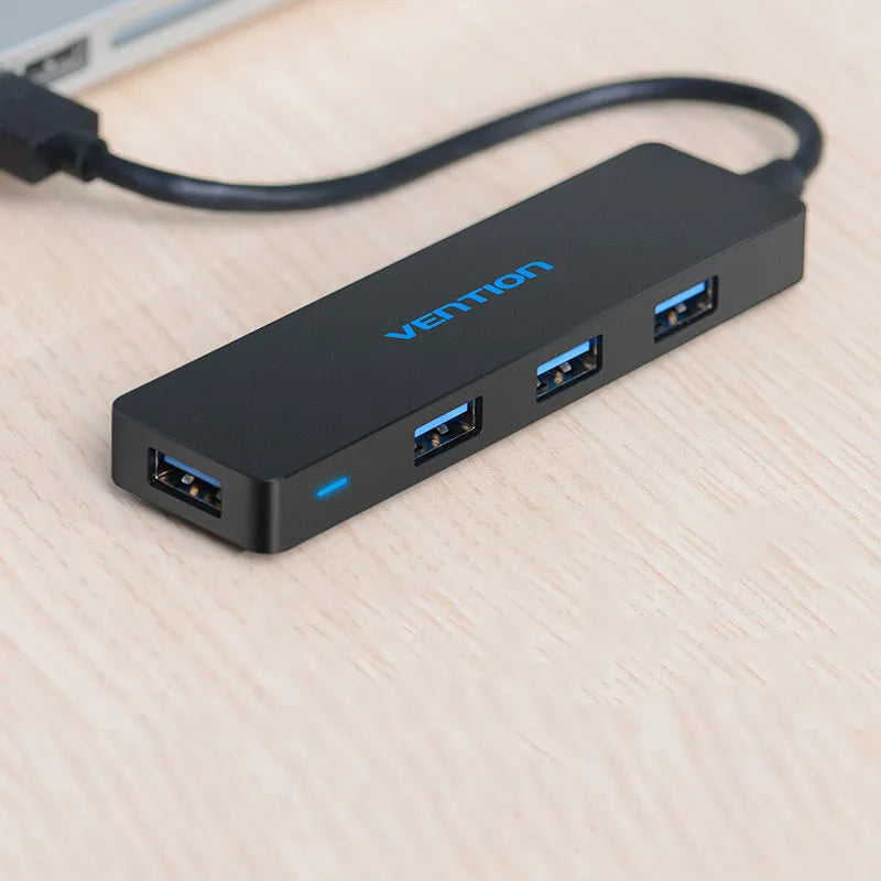 Black four-port USB 3.0 hub with a short cable and nickel-plated connectors