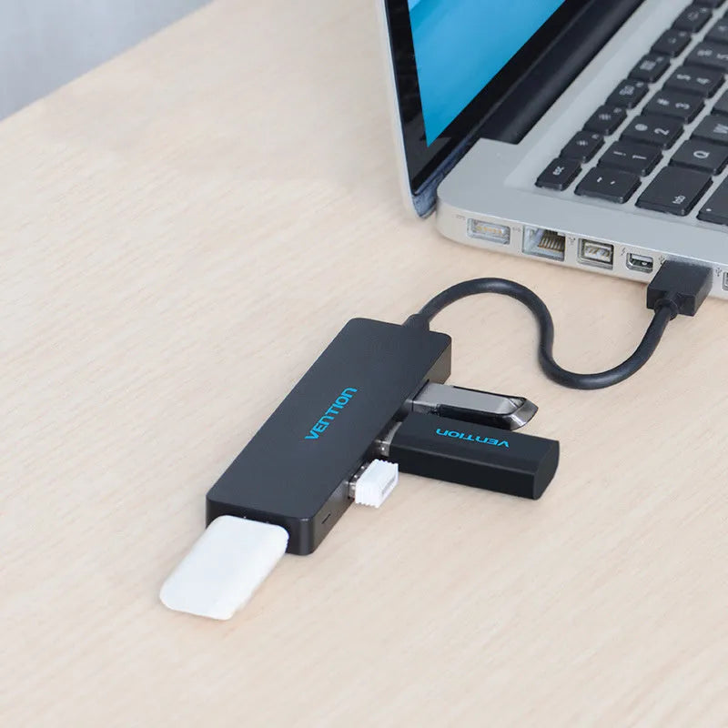 Black four-port USB 3.0 hub with a short cable and nickel-plated connectors